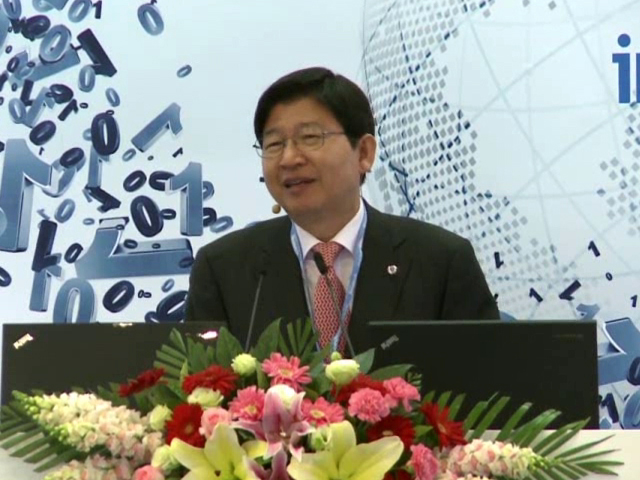 a person in a suit holding a flower