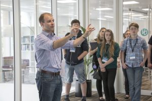 a group of people standing in front of a window