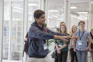 a group of people standing in front of a window