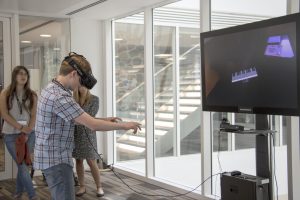 a woman standing next to a window