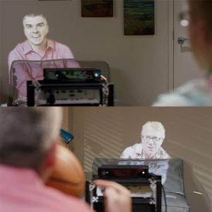 Room2Room: Life-Size Telepresence in a Projected Augmented Reality Environment