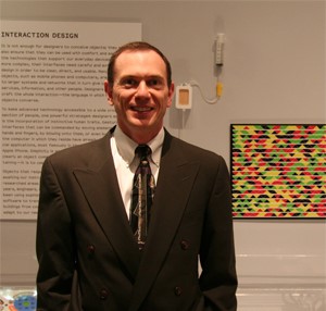 Gavin Jancke at the Museum of Modern Art in front of his multicolored high-capacity barcode.