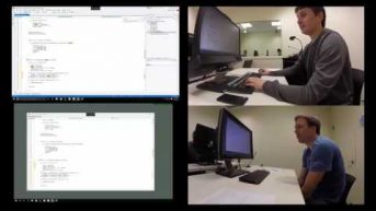 a man standing in front of a computer screen