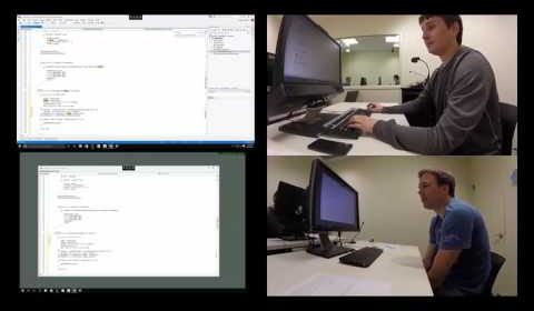 a man standing in front of a computer screen