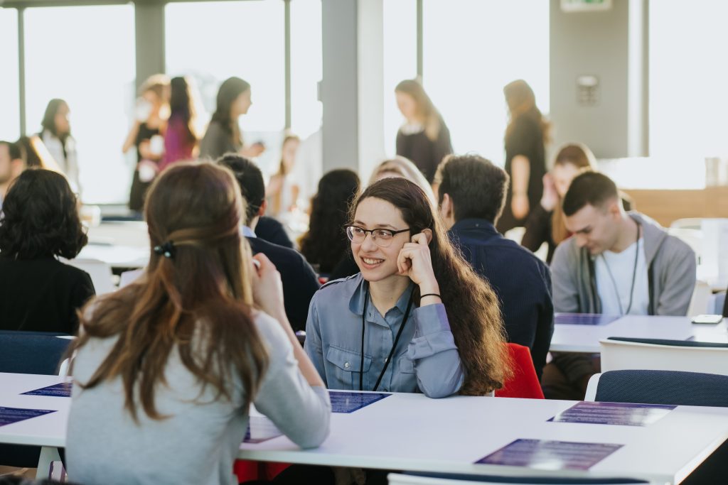 a group of people looking at a laptop