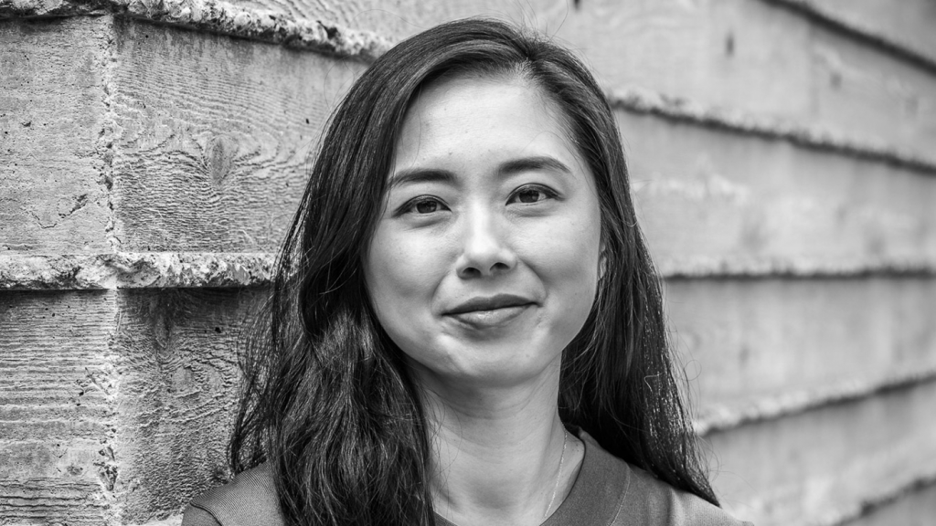 haiyan zhang standing in front of a wall