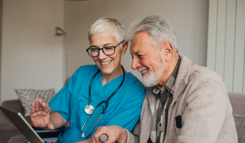 a man sitting in front of a laptop