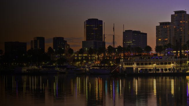 Rainbow Harbor at Long Beach Marina, California with city skyline at sunset