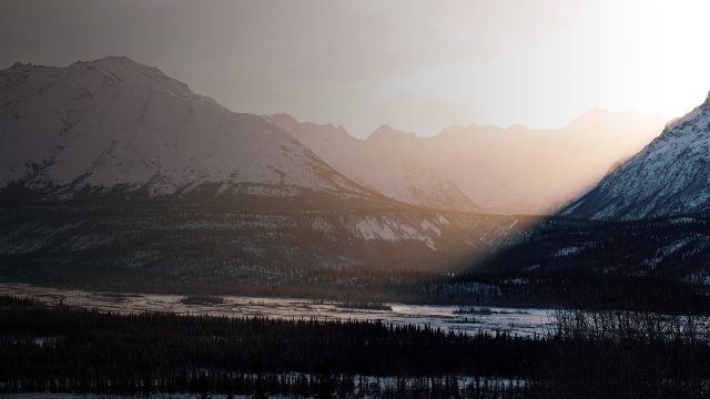 sun setting over mountain ranges in Anchorage, Alaska