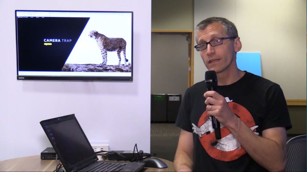 David Cordani sitting at a table using a laptop computer