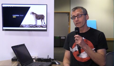 David Cordani sitting at a table using a laptop computer
