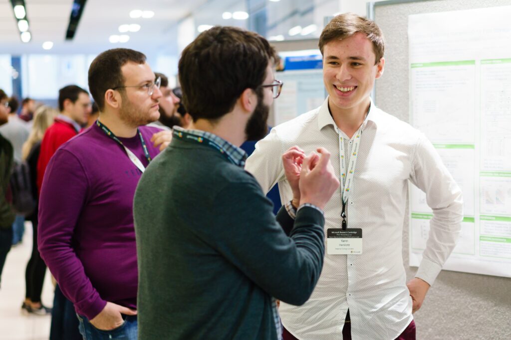 a man and a woman standing in front of a crowd