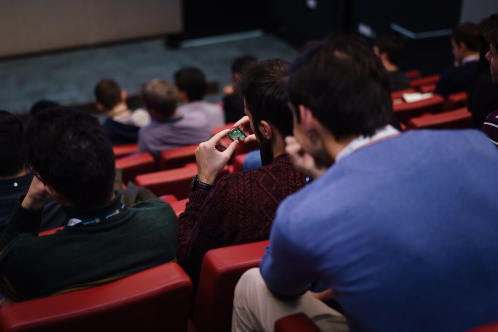 a group of people sitting in front of a crowd