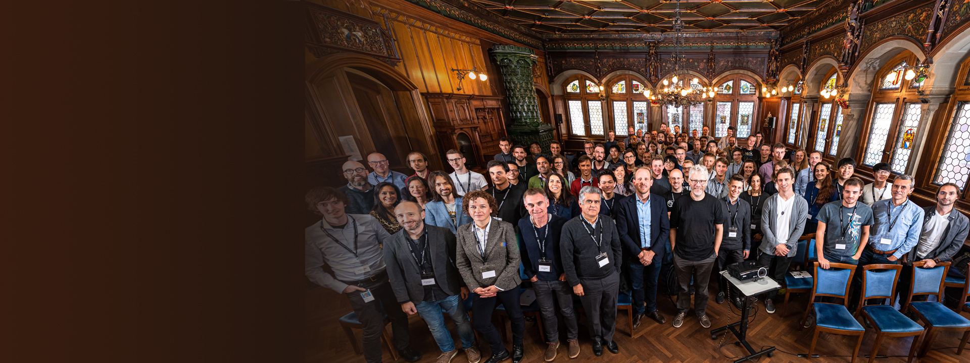 a group of people standing in front of a crowd posing for the camera