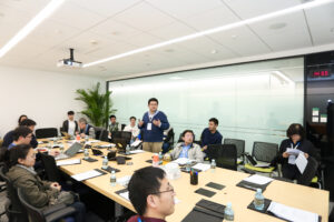 a group of people sitting at a desk