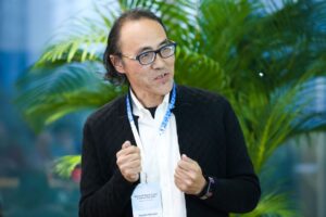 Prof Lawrence Jun Zhang wearing a suit and tie