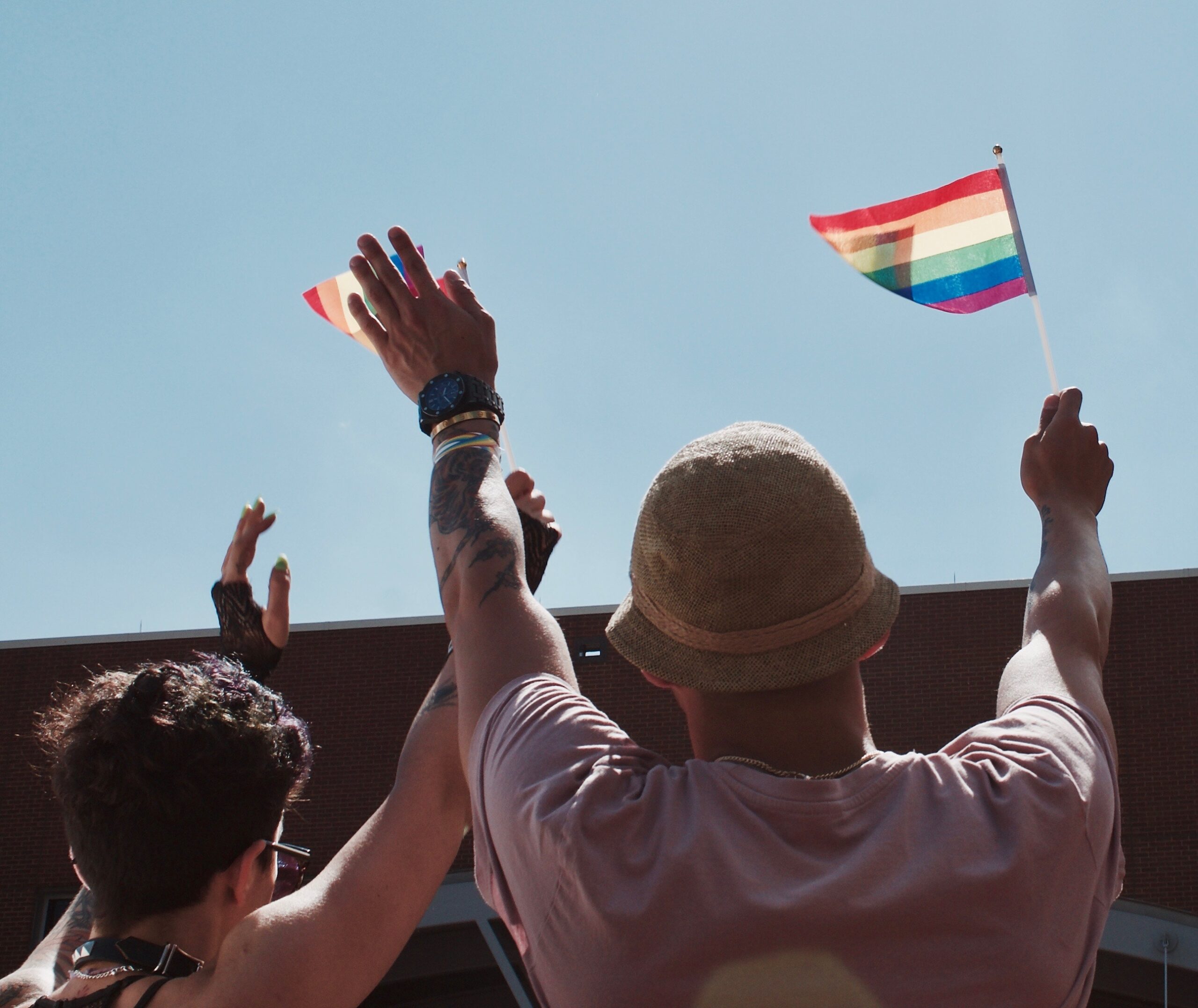 Participants wave rainbow flag
