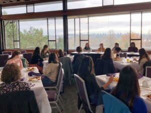 Photograph of students in a room, listening to a panel discussion