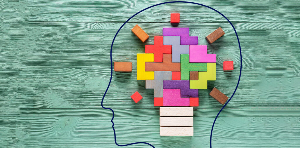 An illustration of a human head with colored tiles within it.