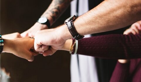 group of people bumping fists