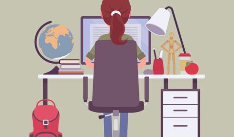 female student at computer with laptop