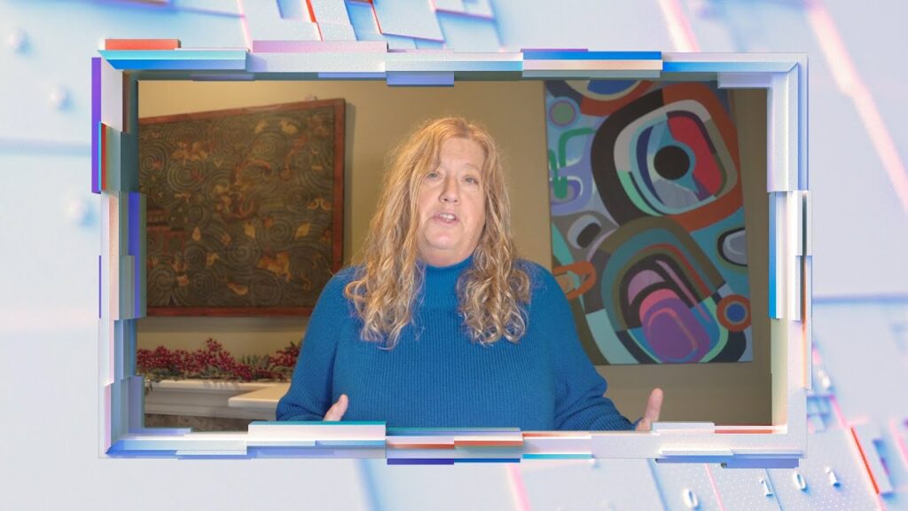 Allie Raye standing in front of a computer screen