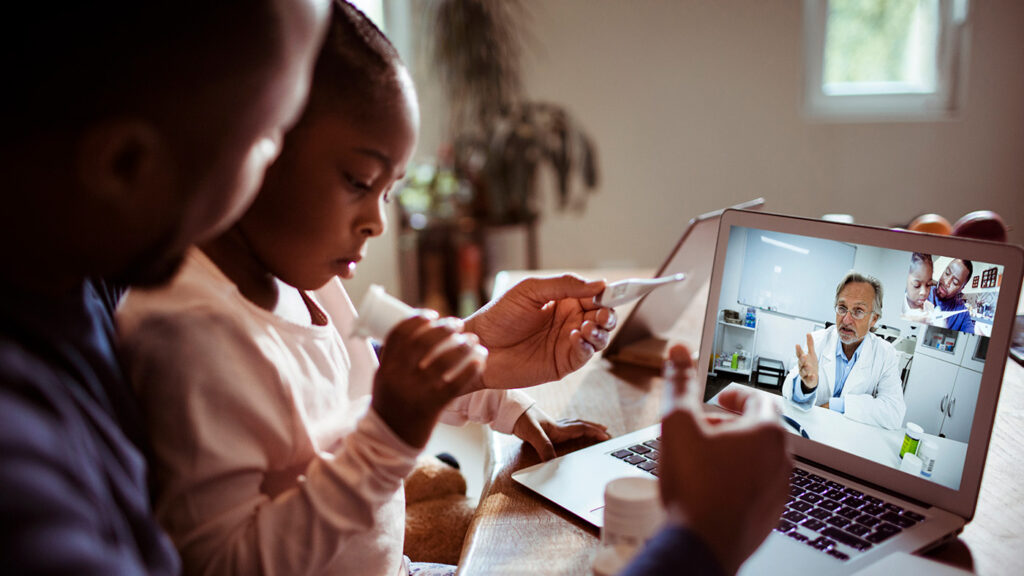 AI for Good - health equity - photo of a parent and child in a televisit with a doctor