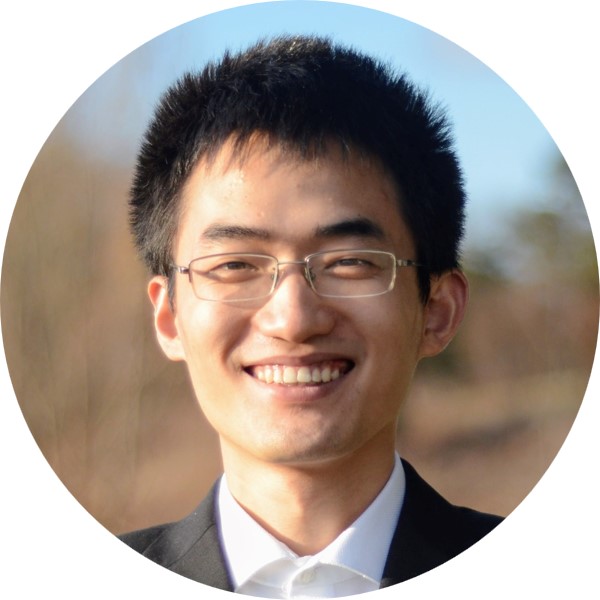 a man wearing a suit and tie smiling at the camera