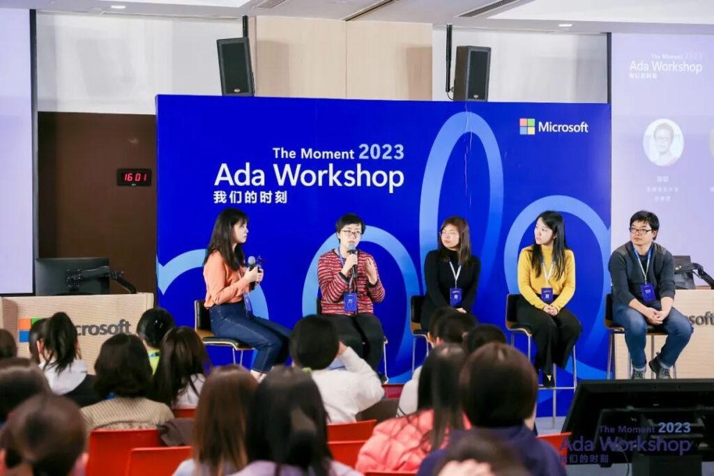 a group of people standing in front of a screen