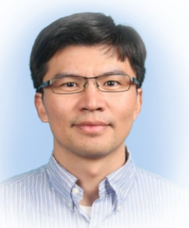 a man wearing glasses and smiling at the camera