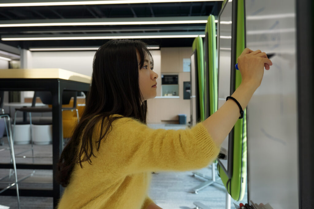 a woman standing in front of a mirror posing for the camera