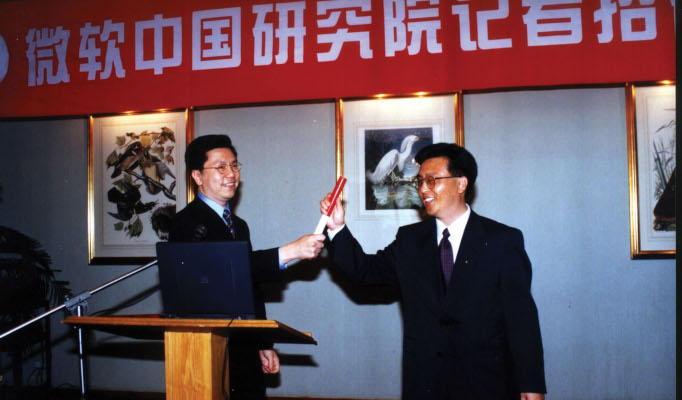 a man in a suit standing in front of a store