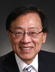 Andrew Yao wearing a suit and tie smiling at the camera