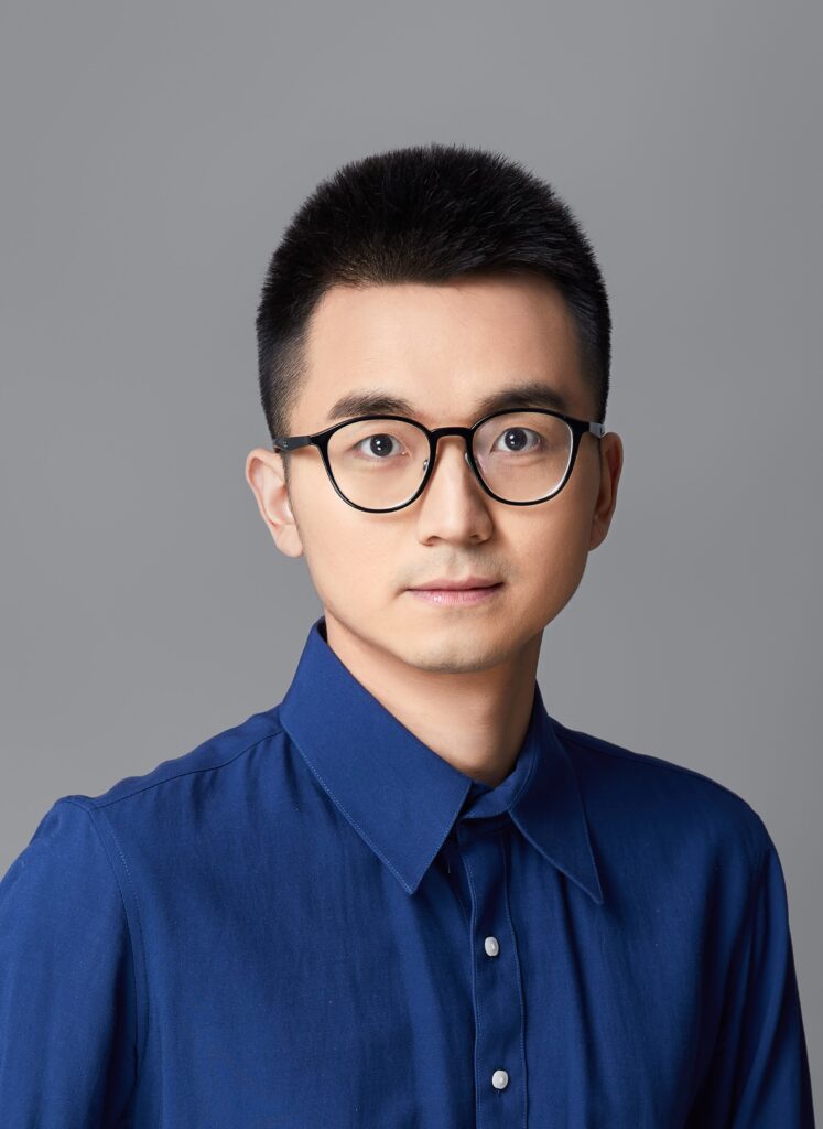 a man wearing glasses and looking at the camera