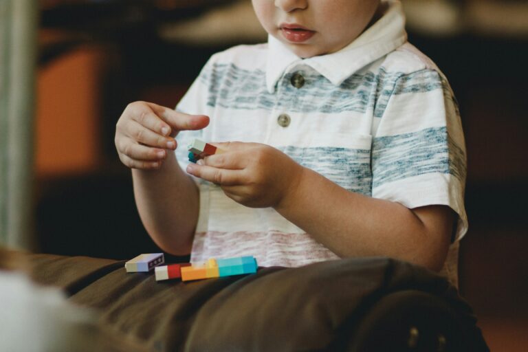 close up of a toddler playing with interlocking blocks