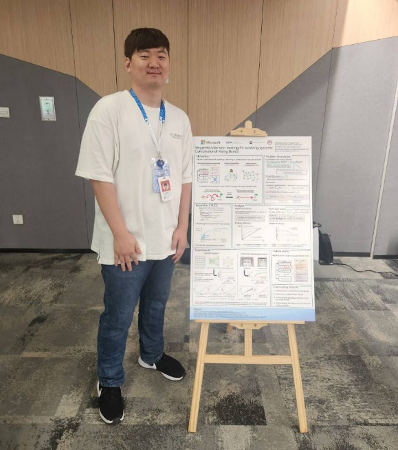 a man standing next to a sign