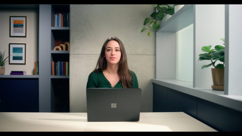Jeanine Mason sitting at a table with a laptop