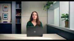 Jeanine Mason sitting at a table with a laptop