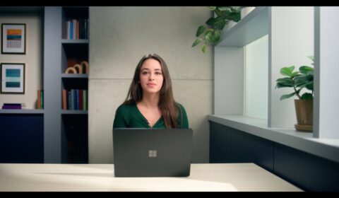 Jeanine Mason sitting at a table with a laptop
