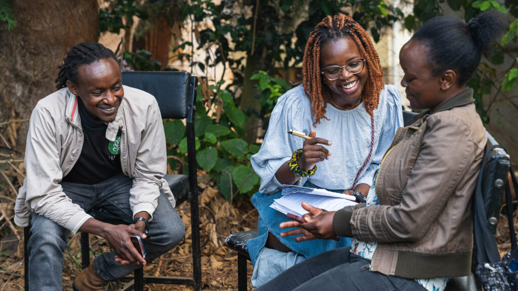 Stephanie Nyairo of Microsoft Research (center) collaborates with members of Digital Green to help farmers address the challenges of climate resilience.