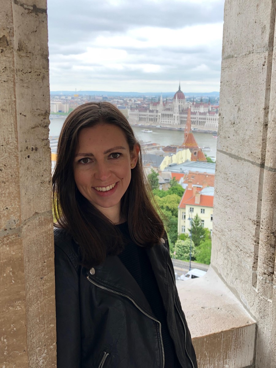 Maria Puertas Calvo leaning against a wall next to an open window.
