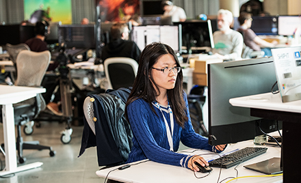 Image of a woman at her desk.