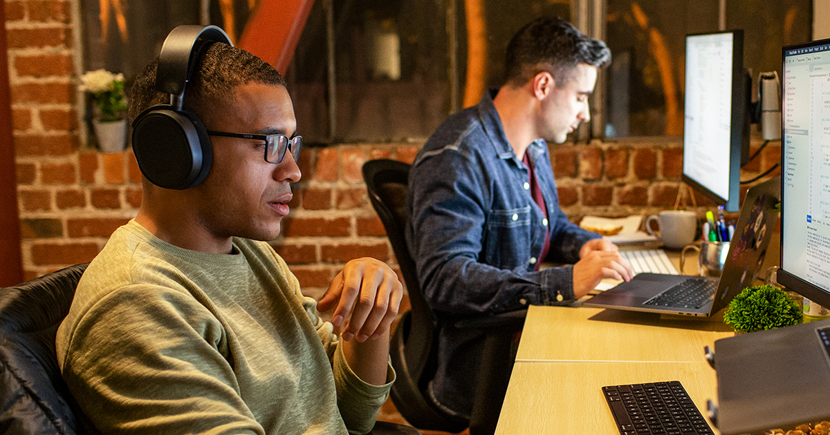Two men at PC workstations.