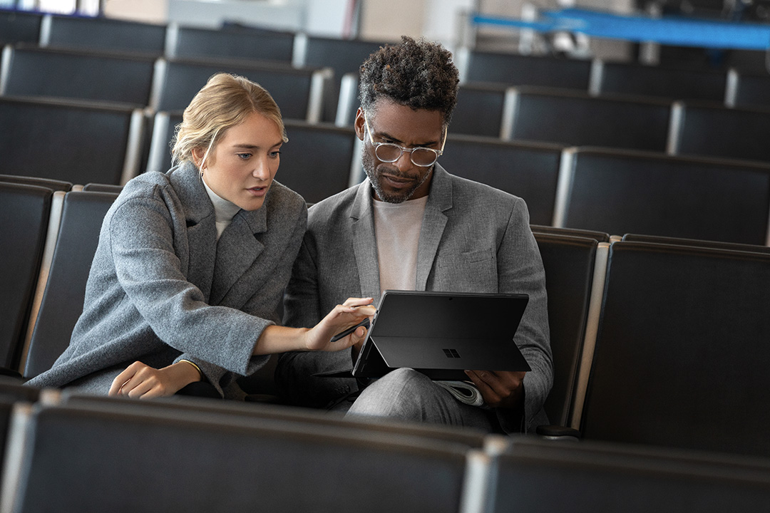 Contextual image of man and woman collaborating while working on Surface Pro6