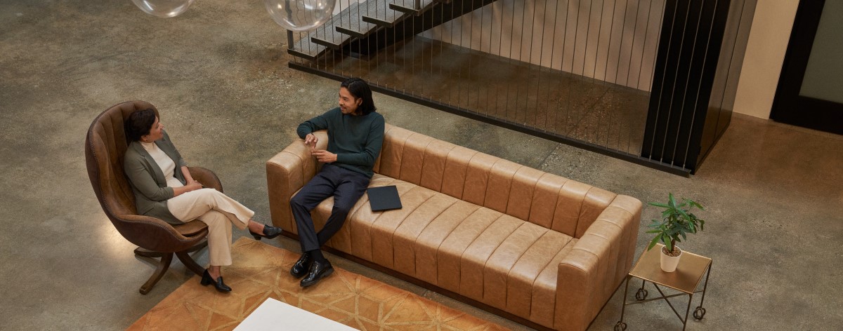 Decision maker (DM) collaborating in an open, casual space.