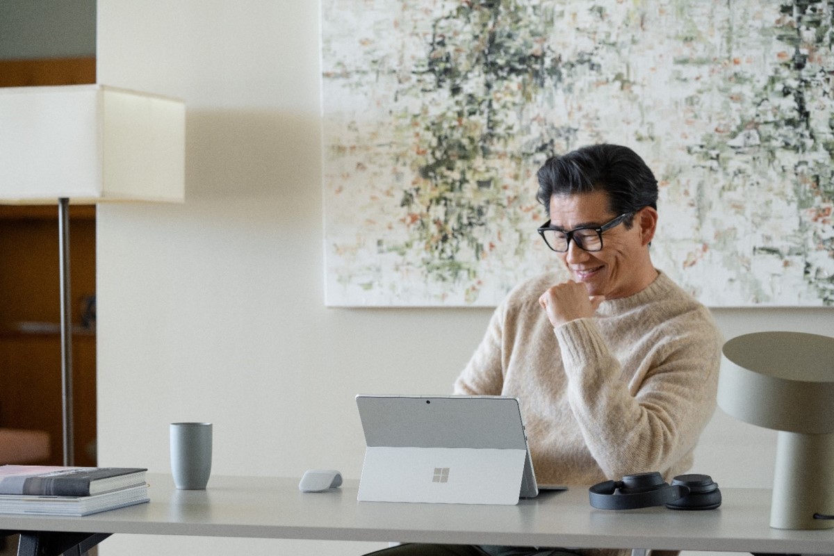 Hybrid employee working in home office on portable device.