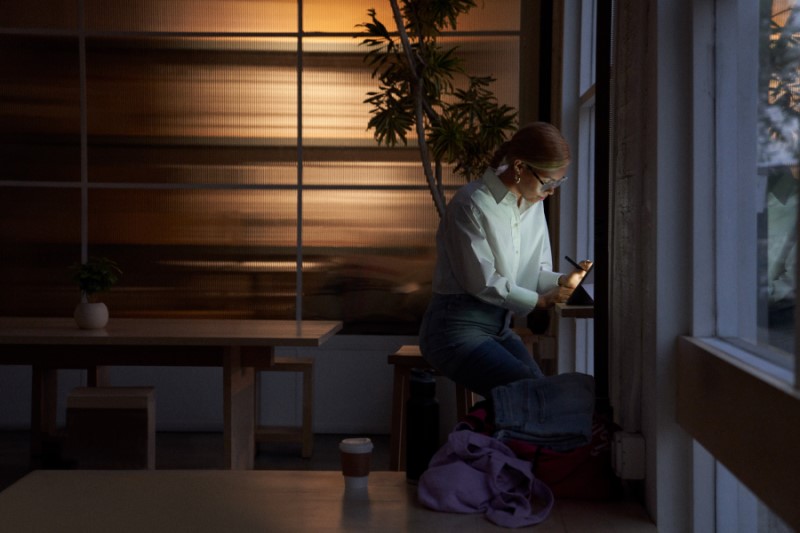 Retail store manager using a tablet while working remote from a cafe.