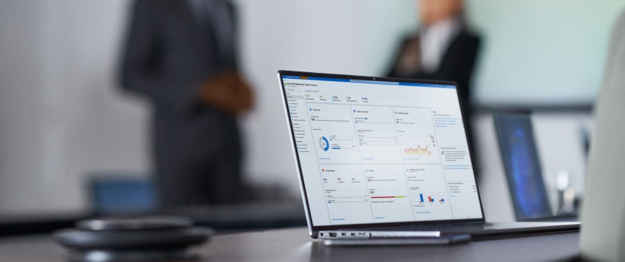Camera focused on laptop screen showing security dashboard while security decision makers present to the board of executives on security topics.