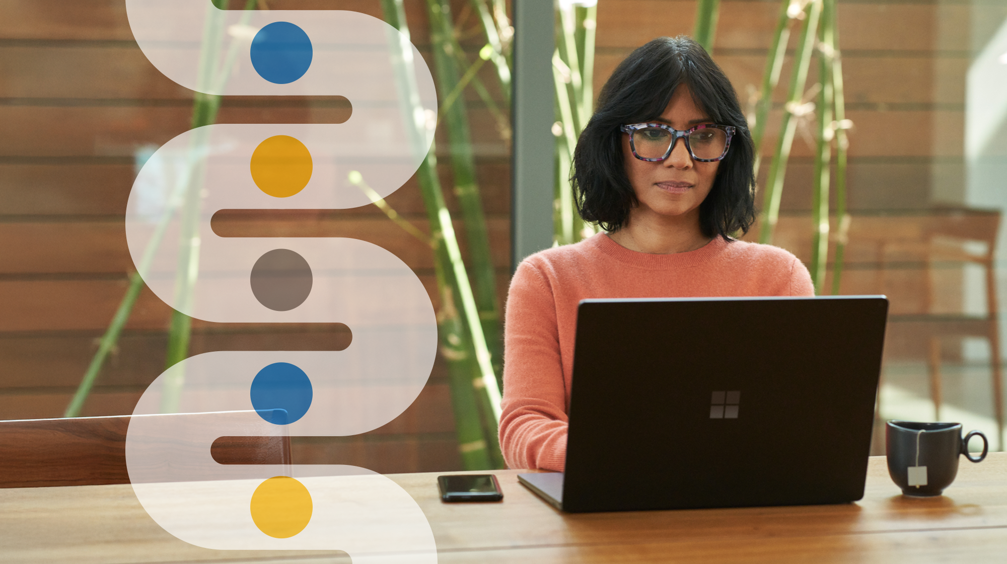 Business decision maker (BDM) working from home on a laptop with decorative security branded imagery