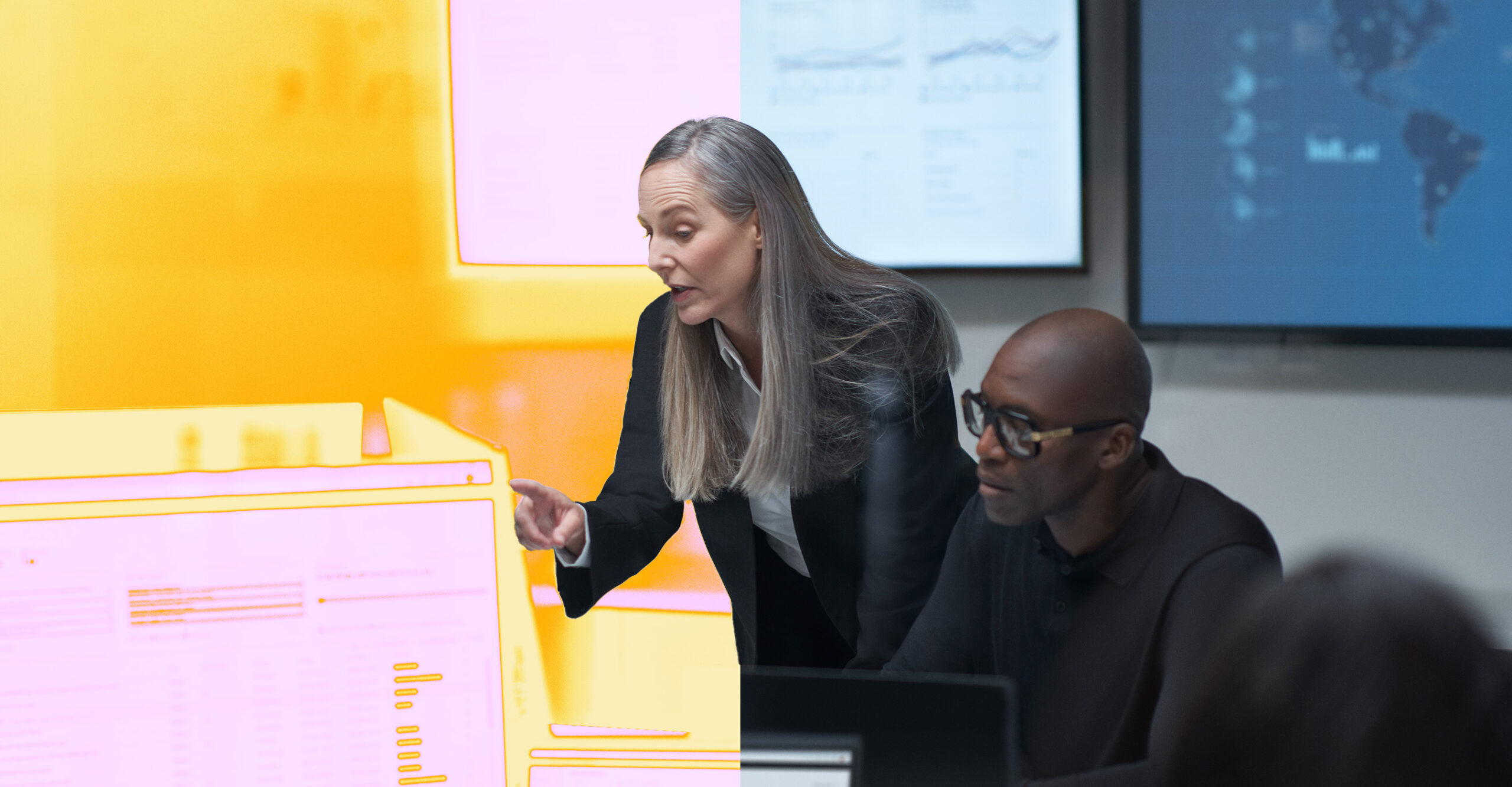 A woman pointing at a computer screen.